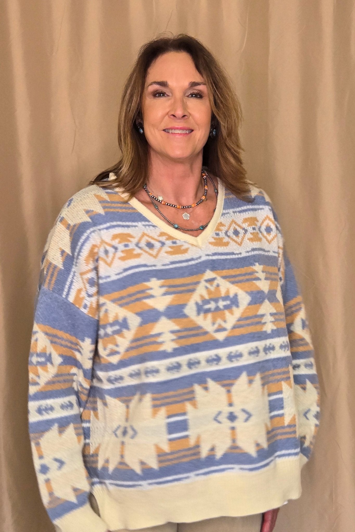 Main Strip Southwestern Knit Sweater — Oversized V-Neck with Bold Blue, Tan & Cream Print Cowhide and Conchos