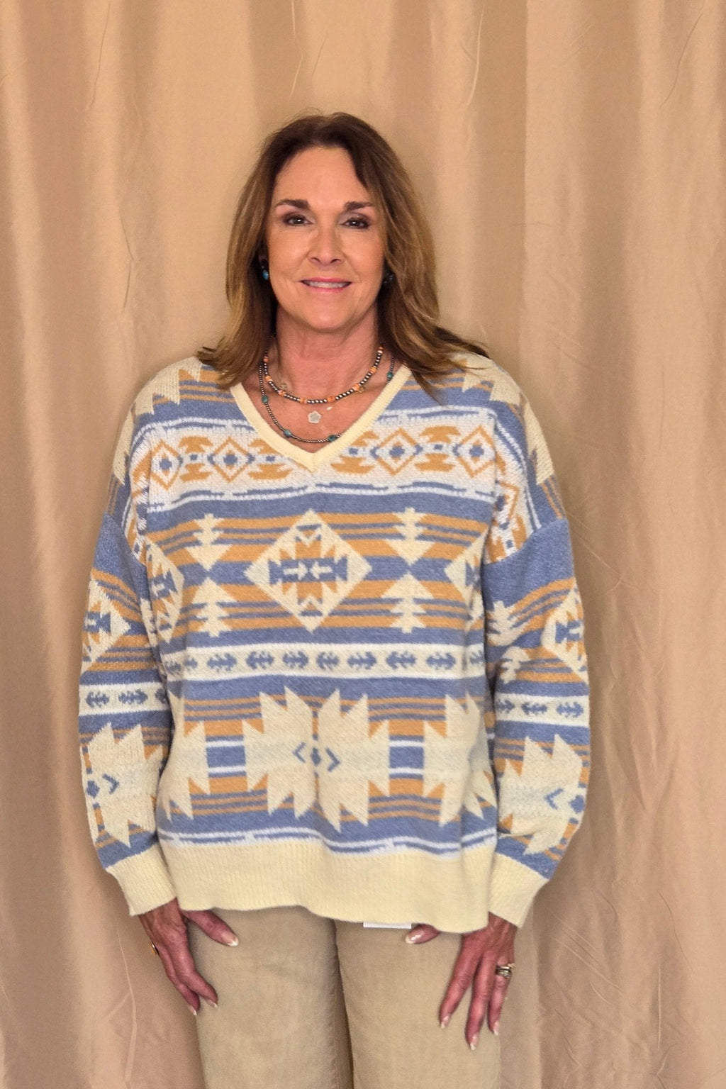 Main Strip Southwestern Knit Sweater — Oversized V-Neck with Bold Blue, Tan & Cream Print Cowhide and Conchos