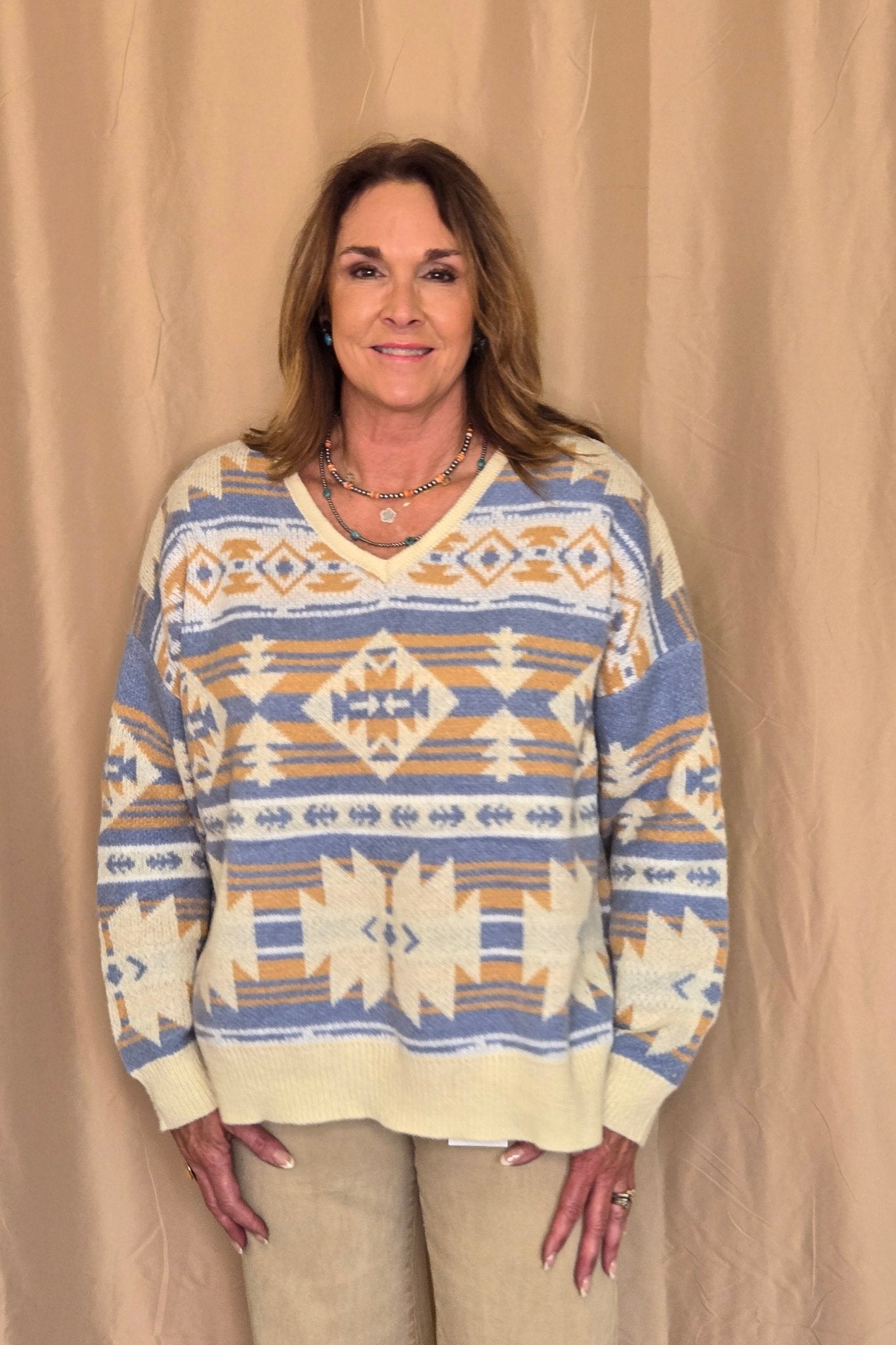 Main Strip Southwestern Knit Sweater — Oversized V-Neck with Bold Blue, Tan & Cream Print Cowhide and Conchos