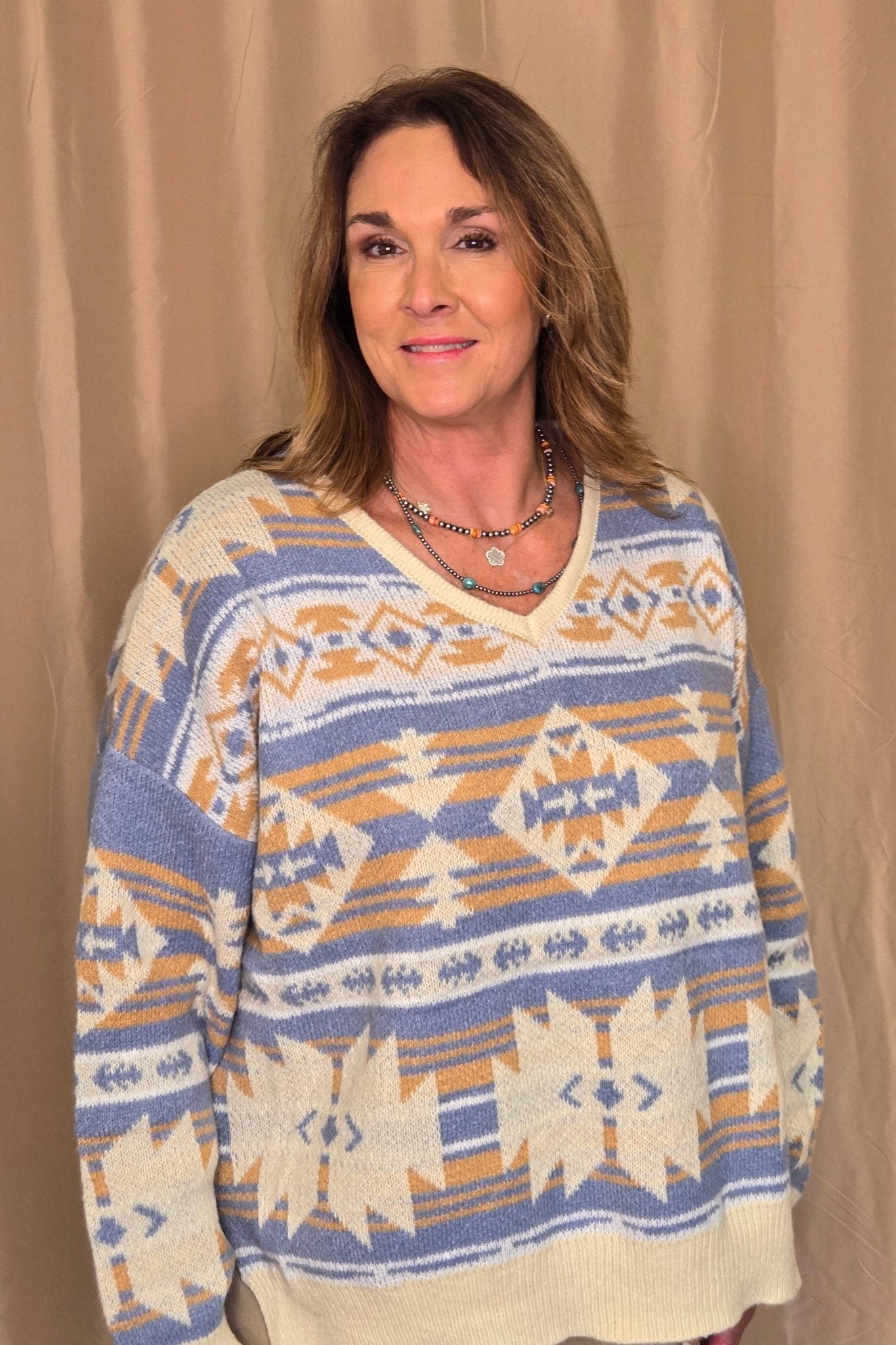 Main Strip Southwestern Knit Sweater — Oversized V-Neck with Bold Blue, Tan & Cream Print Cowhide and Conchos