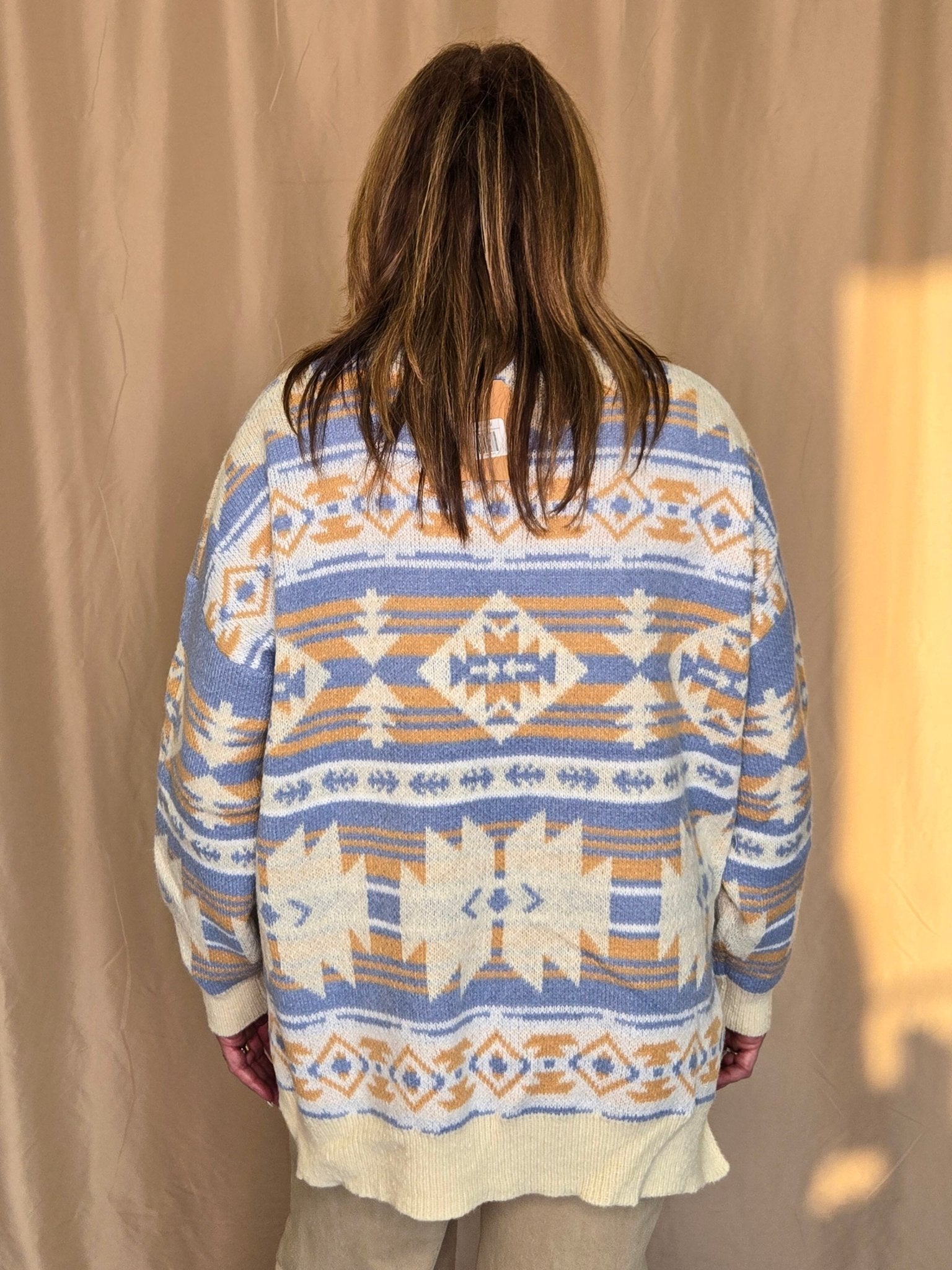 Main Strip Southwestern Knit Sweater — Oversized V-Neck with Bold Blue, Tan & Cream Print Cowhide and Conchos